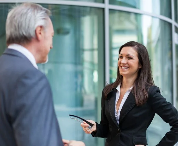 Image of two people talking in a business setting